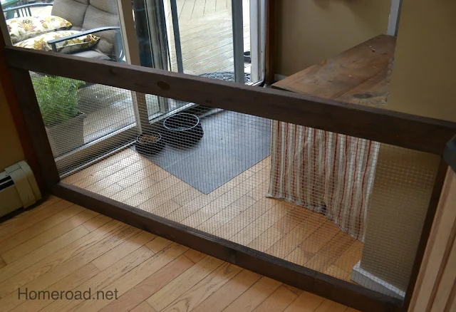 Dog fence in corner with feed bowls