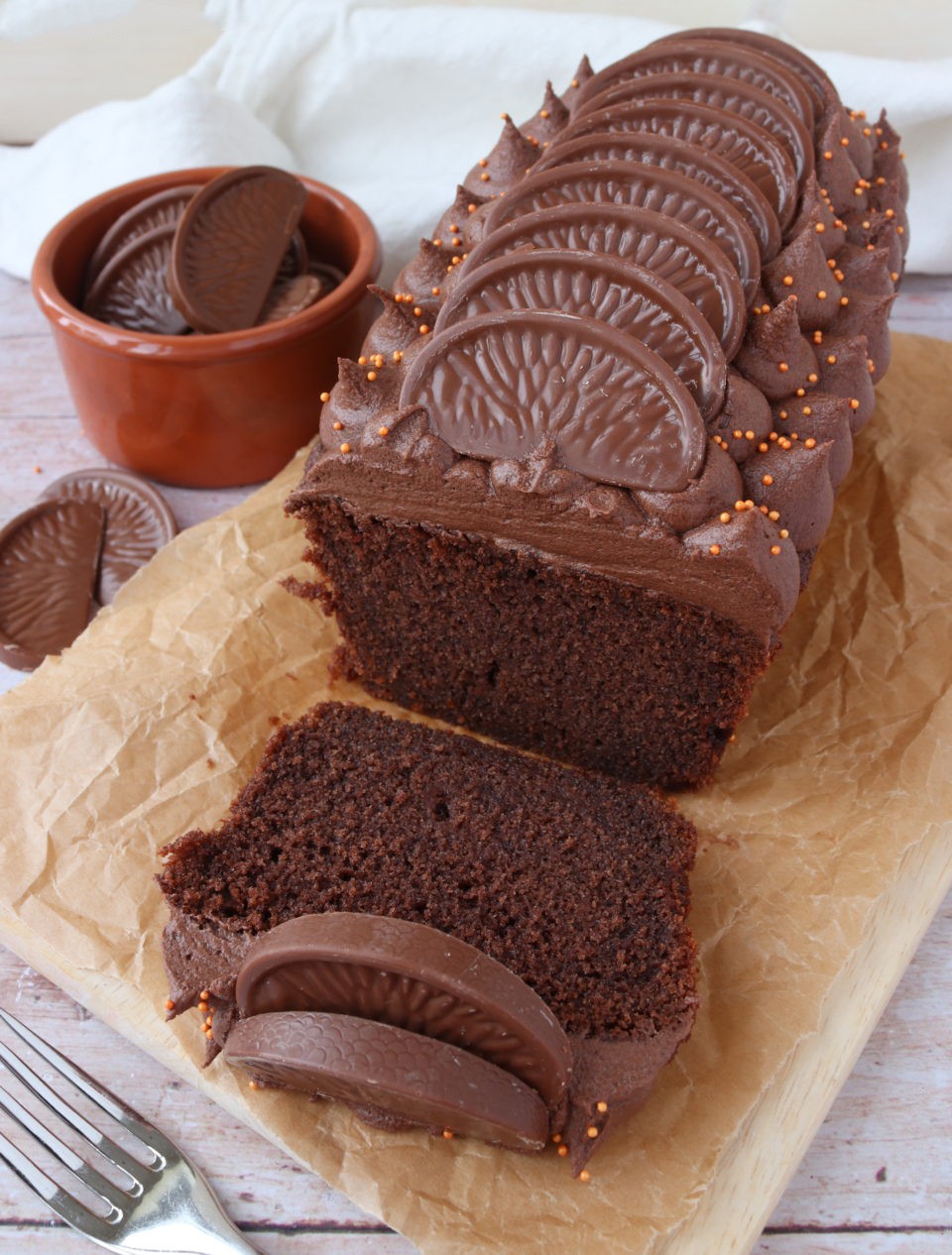 Chocolate Orange Loaf Cake - Delicious Chocolate Orange Loaf Cake decorated with chocolate orange buttercream and Terry's Chocolate Orange pieces - easy to follow recipe!