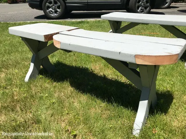 A wooden bench with curved edges cut into it