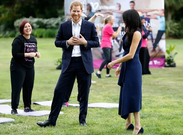 Meghan Markle wore a folded sail dress by Australian fashion designer Dion Lee, Martin Grant coat, Gucci Sylvie bag, Manolo Blahnik suede pumps