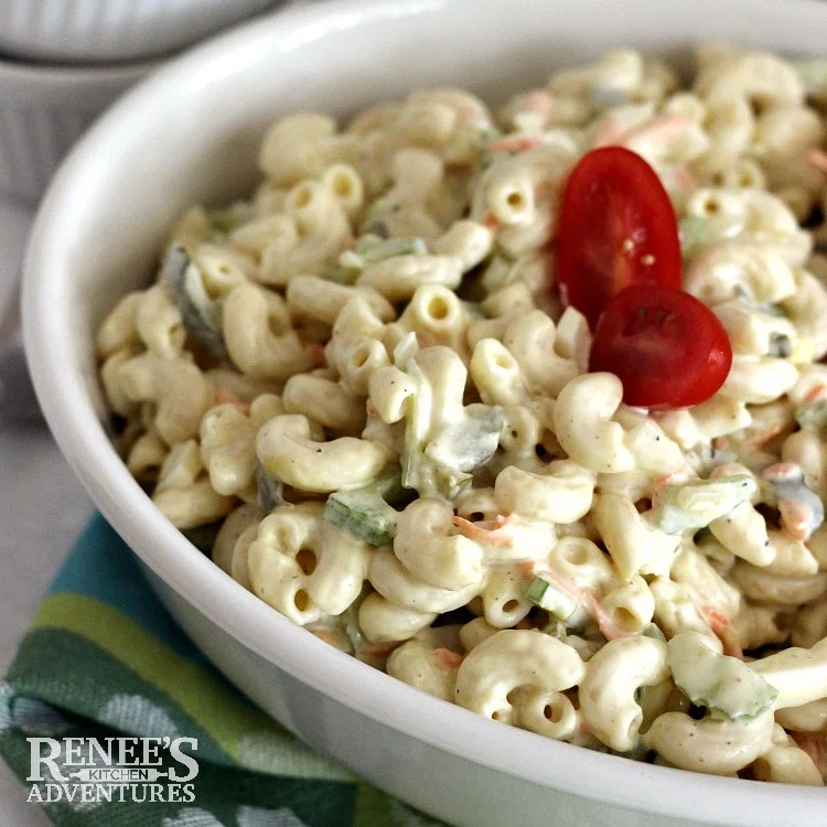 Amish Macaroni Salad by Renee's Kitchen Adventures in a white bowl garnished with two halves of grape tomatoes