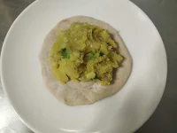 Potato mixture at the center of flat bread for aloo paratha recipe