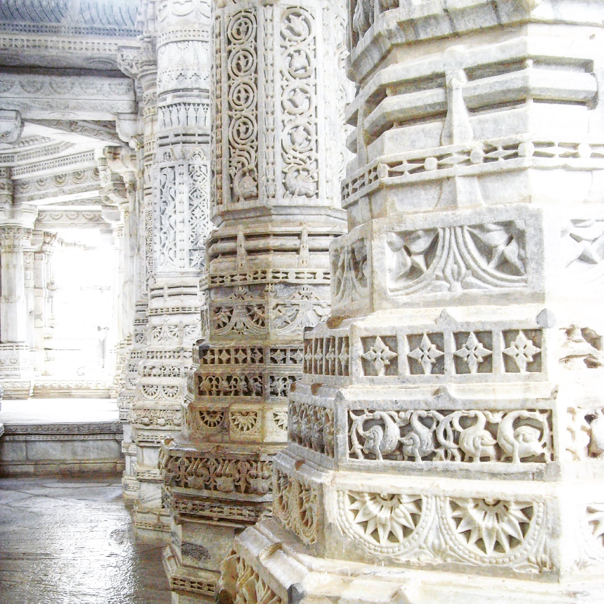 white carved marble pillars inside jain ranakpur temple india