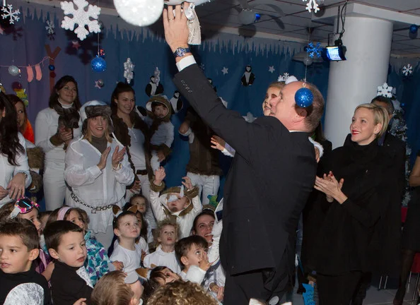 Prince Albert II and Princess Charlene distribute gifts to the children of the Monaco Red Cross School in Monaco