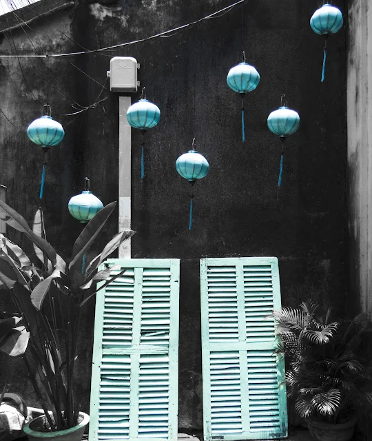 Blue lanterns and shutters in Hoi An Vietnam