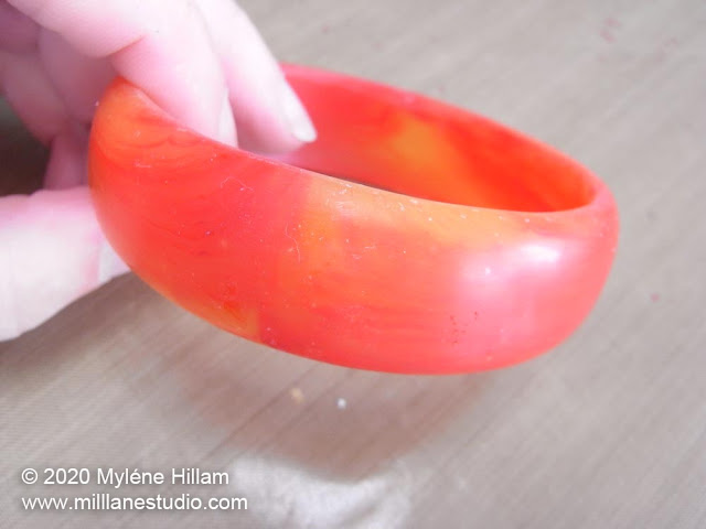 Red and orange half-round bangle with a satin finish