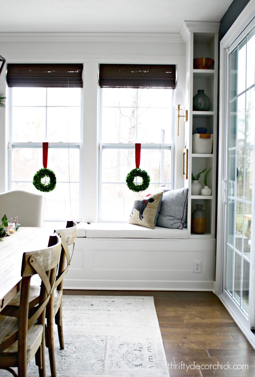 Wall of window seat with bookcases in dining room 