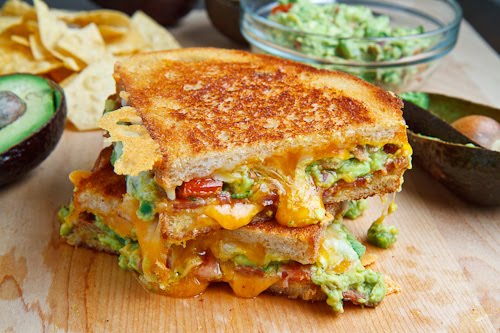 A buttery and toasty grilled cheese sandwich stuffed with cool and creamy guacamole, crispy bacon and melted jack and cheddar cheese. The crunchy crumbled tortilla chips in this grilled cheese pay tribute to the classic combination of tortilla chips and guacamole dip A buttery and toasty grilled cheese sandwich stuffed with cool and creamy guacamole, crispy bacon and melted jack and cheddar cheese. The crunchy crumbled tortilla chips in this grilled cheese pay tribute to the classic combination of tortilla chips and guacamole dip