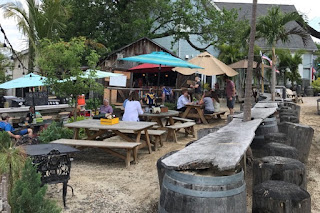 Beer garden with sand and tropical trees