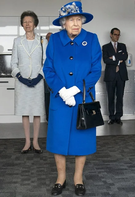 The Queen wore a royal blue velour coat by Stewart Parvin, a matching silk dress. Prince Albert's Sapphire brooch