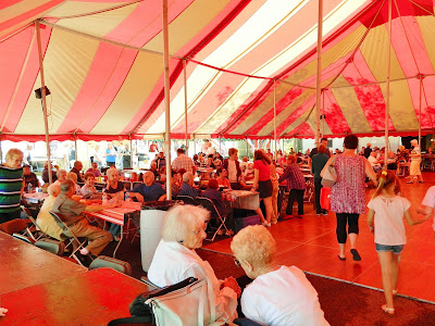 People sitting under the tent at the Toledo Polish American Festival