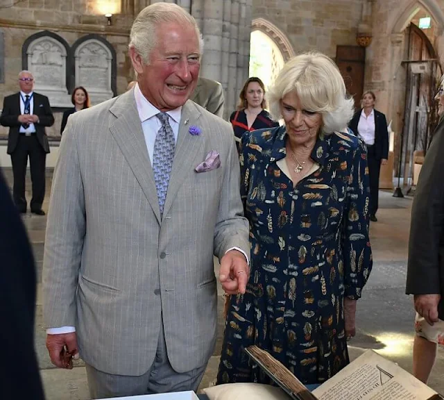 Charles wearing a crisp grey suit and Camilla wore her favourite dress by Fiona Clare