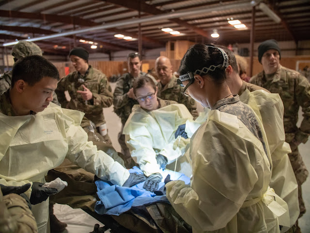 A group of people work on a trauma exercise.