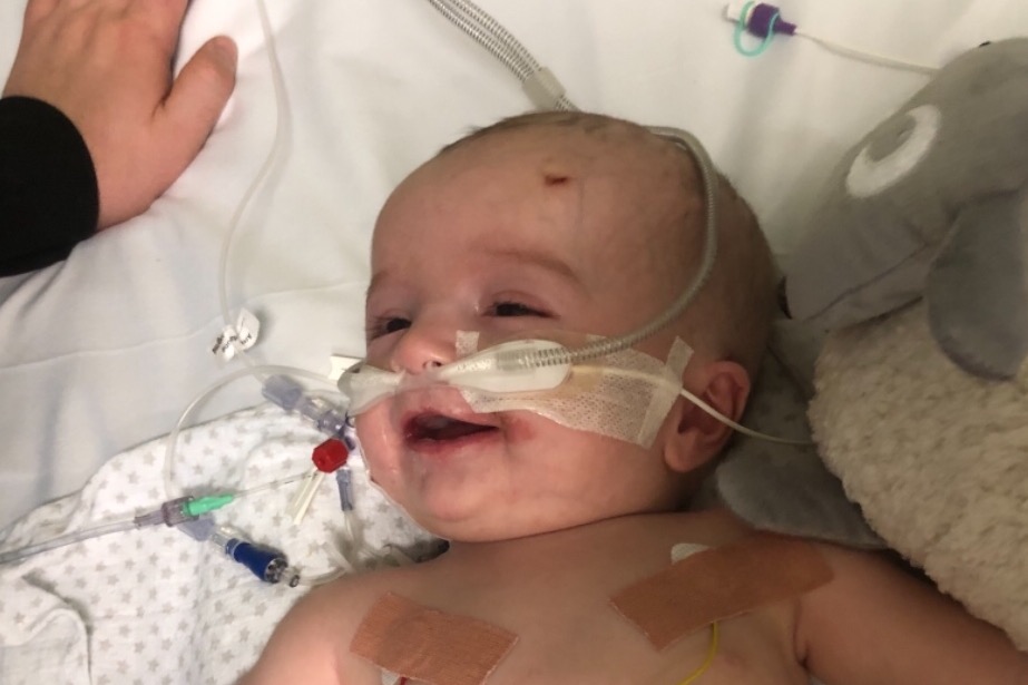 Adorable baby wakes up from coma with smile for dad