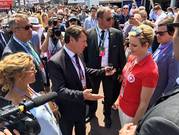 Prince Albert and Princess Charlene at Formula 1 Grand Prix. Princess Charlene wearing the T Shirt of the red cross of Monaco