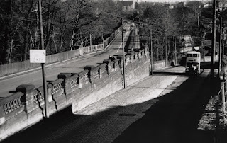 A view of Armstrong Bridge with a bus coming up Benton Bank to the right