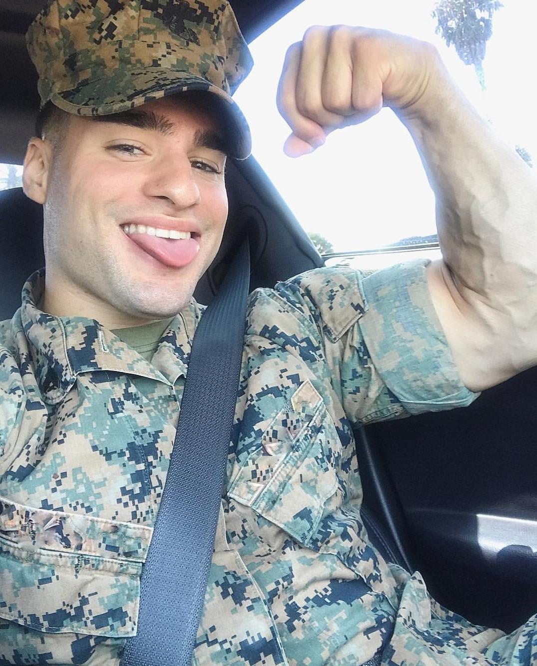 cute-tongue-out-male-soldier-car-flexing-biceps-veiny-arms-military-uniform