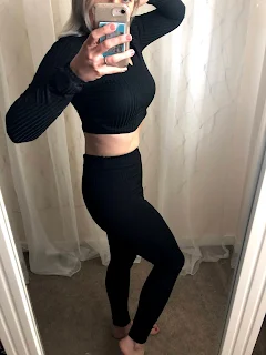 woman with blog hair posing on cropped black top and leggings femme luxe
