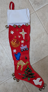 Red velveteen stocking with white felt cuff and sequined decals