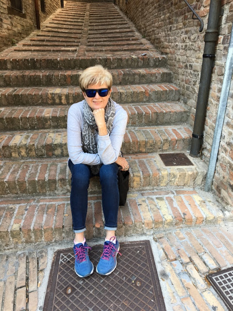 Italy: The View from My Couch. Happy to be away from the crowds in Urbino. woman sitting on stone steps in Urbino, Italy