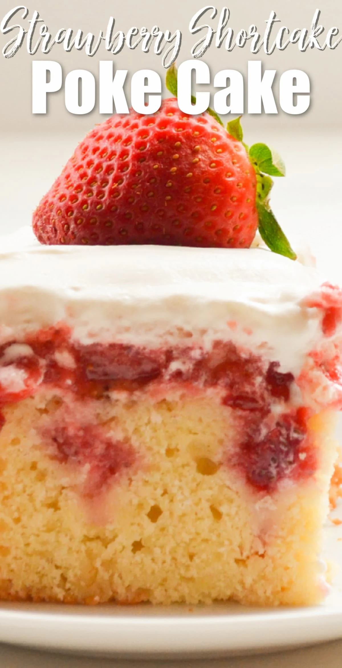 A slice of Strawberry Shortcake Poke Cake with white text at top Strawberry Shortcake Poke Cake.