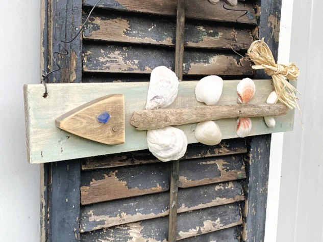 fish art hanging on old shutter