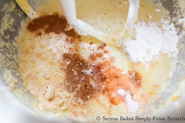 Cranberry Orange Cake Batter with Vanilla, baking soda, baking powder, cinnamon, ginger, salt in mixing bowl.