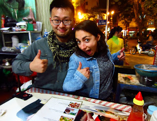 Two tourists pose in a restaurant in Hanoi, Vietnam