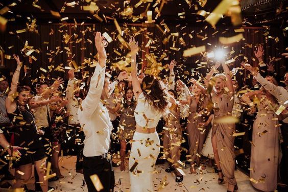 Reception Party wedding ideas - wedding planning services in Philadelphia PA - reception dancing - bride and groom dancing with confetti thrown by guests - wedding ideas blog by K'Mich