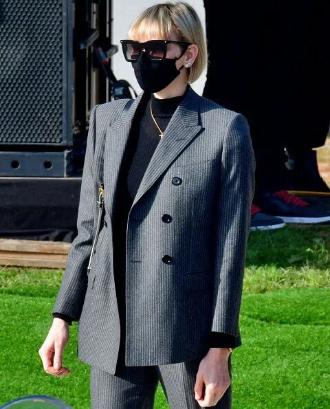 Princess Charlene of Monaco wore a double-breasted grey pinstripe jacket/blazer suit from MaxMara, Ralph Lauren, Akris and Brunello Cucinelli