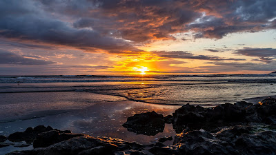 Beautiful sunset clouds, beach, stones, skyline Beautiful sunset clouds, beach, stones, skyline