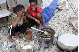 Sisters cooking lunch in Marsabit Kenya Africa