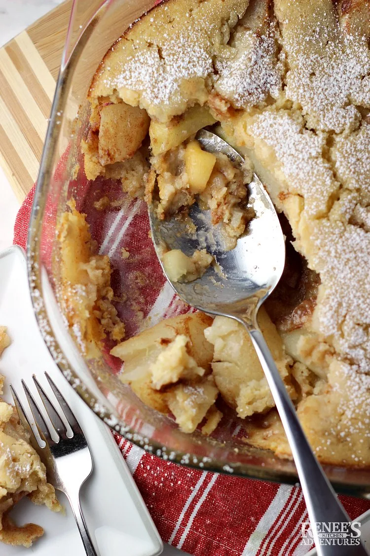 Overhead view of Warm Pear Cobbler by Renee's Kitchen Adventures with spoon and some of the cobbler missing. 