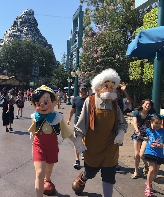 Pinocchio and Geppetto Passing Matterhorn Bobsleds Disneyland