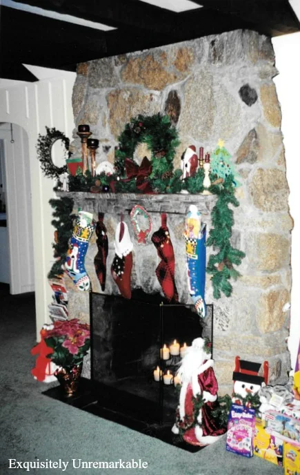 Stone fireplace at Christmas with toys and wreaths