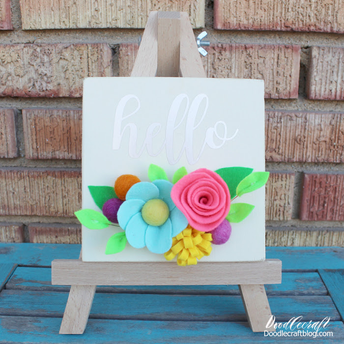 Supplies Needed for Wood Sign with Felt Flowers: (affiliate links) 6x6 inch Wood Board Apple Barrel Antique White Paint Metallic Permanent Adhesive Vinyl Cricut Maker Felt Sheets in Various Colors (I chose brights) Felted Balls Floral Wire Scissors Paintbrush Hot Glue/Gun