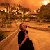 Ritsopi Panayiota, 81, reacts as the wildfire is reaching her house in the village of Gouves on Evia island, Greece on August 8, 2021. for Bloomberg (Picture)