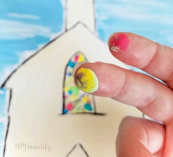 paint stained glass window with fingertips dipped in paint