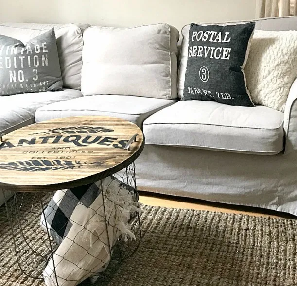 Wooden tray storage as coffee table filled with pillows and blankets