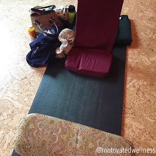 At Bodhi Yoga studio for yoga teacher training Yoga mat with bolsters and personal belongings to the side