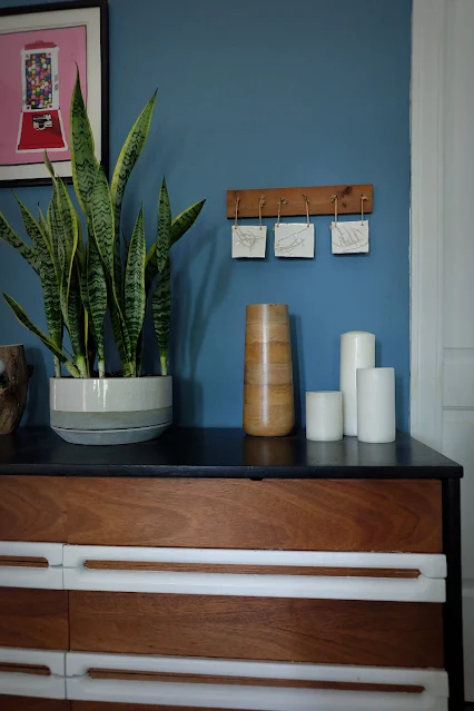 decorated dresser in front of repaired wall from pocket door install