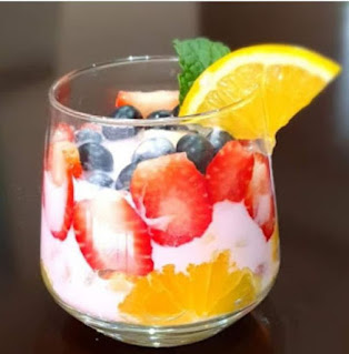 A simple fruit salad is the perfect side dish. It's great for serving for any time of the day. Glass Jars of blueberries,strawberries,grapes,bananas,orange,fruit loops,sour cream with mint on top. This simple mixed fruit salad is nutritious and easy to make.