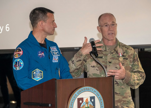 Andrew Morgan stands at a podium next to Richard Scheuring.