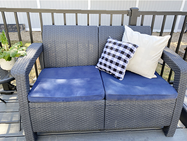 love seat with painted blue cushions and pillows