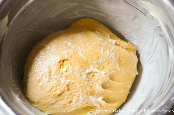 Pumpkin Cinnamon Roll Dough in a well buttered bowl.