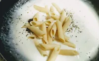 Cooking penne pasta for pasta in white sauce recipe