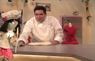 Jean the Genie summons Emeril Lagasse for to make pizza. Elmo is happy. Sesame Street Elmo's Magic Cookbook