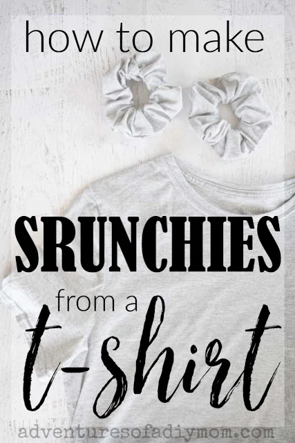 a grey t-shirt and two scrunchies laid out on a painted wood background. The words "how to make scrunchies from a t-shirt" overlaid on top.