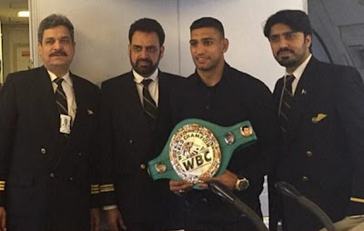 Boxer Khan showing off his belt with the crew in pakistan
