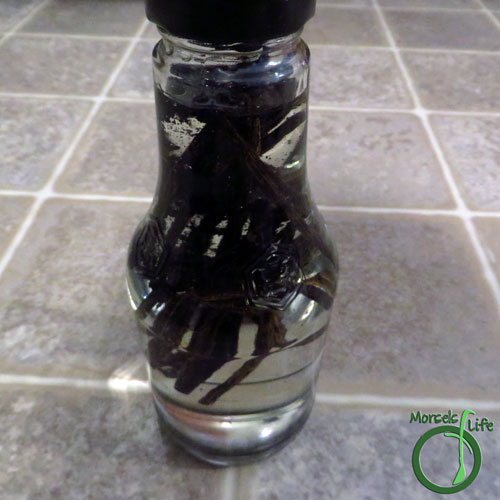 Morsels of Life - Alcohol Free Vanilla Extract Step 3 - Place all vanilla beans and scrapings into container with glycerin and shake well to mix.